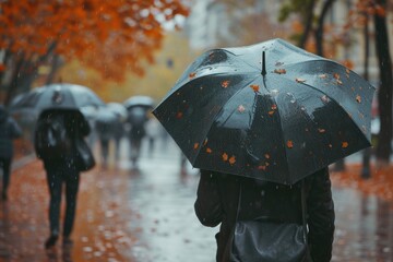 Aufkleber - A person standing in the rain, holding an umbrella. Perfect for illustrating rainy weather or protection from the elements
