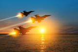 Fototapeta  - Air Force Day. Aircraft silhouettes on background of sunset on the sea.