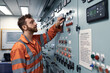 © Igor Hotinsky - Young marine engineer monitoring work of electrical equipment in engine control room.