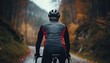 Close up of man in sport clothing standing behind nature with black bicycle. Athlete cyclist in outdoor nature healthy active lifestyles.