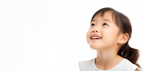 asia little girl looking up isolated over white background.