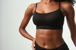 © Enrique - Young black woman with flat belly white background, closeup. Plastic surgery concept