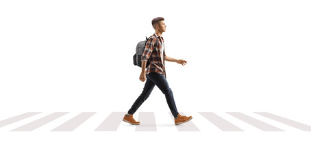 Wall Mural - Full length profile shot of a male teenage student with a crossing a street