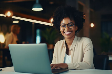 Ambitious Businesswoman: Young African American Woman in Modern Office - Happy and Successful, Working with Laptop - Professional Lifestyle and Confidence - Banner of Diversity and Business Success