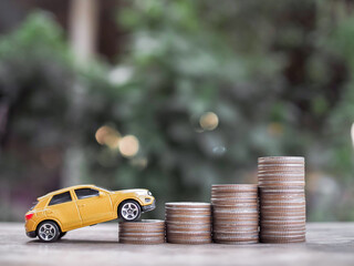 Canvas Print - Toy cars on stack of coins. The concept of saving money and manage to success transport business