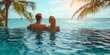 Couple relaxing in swimming pool at tropical resort. Honeymoon concept