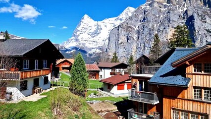 Canvas Print - Switzerland nature and travel. Alpine scenery. Scenic traditional mountain village Murren surrounded by snow peaks of Alps. Popular tourist destination and ski resort. 4k hd video