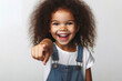 Joyful young girl with curly hair pointing finger isolated on solid white background. ai generative