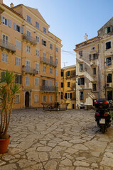 Romantic backstreet, side street or alleys in historic old town of Corfu Island, Greece with Mediterranean style architecture facades, a landmark sightseeing tourist spot in downtown Aegean Sea