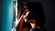 © TopMicrobialStock - Worried woman illuminated by light from a window