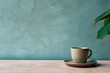© Nadia - a coffee cup sitting on a saucer with a green plant in the middle of the cup and a blue wall in the background.