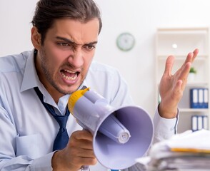 Canvas Print - Young male businessman employee unhappy with excessive work