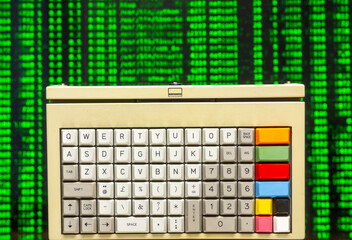 vintage computer keyboard with streaming data and code