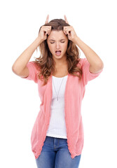 Wall Mural - Woman, playful and devil horns in studio, bully and naughty gesture for attitude on white background. Female person, bad girl and fingers for emoji, bull and comedy or humor on isolated backdrop