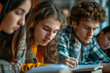 © Fotograf - A group of young people sitting at a table engaged in writing. Suitable for educational, creative, or collaborative themes