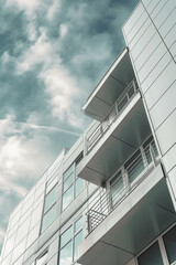 Aufkleber - A picture of a tall building with multiple balconies. Suitable for architectural design projects or real estate advertisements