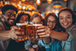 Group of happy friends drinking and toasting beer at brewery bar restaurant - Friendship concept with young people having fun together at cool vintage pub.
