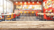 © Dustin - Empty Wooden Table with Blurred Fast Food Restaurant Interior Background