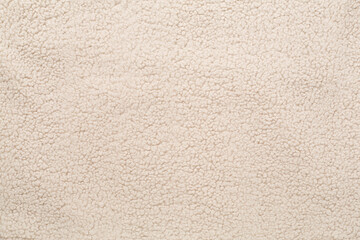 beige cuddle teddy bear fabric as background, top view