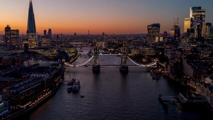 Wall Mural - Aerial hyper time lapse view of the iconic Tower Bridge and river Thames during clear winter dusk, England