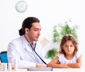 Wall Mural - Young doctor pediatrician with small girl