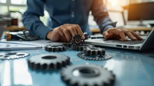 Maintenance Engineer Working On Desk And Pointing Gears Graphic Signifies Maintenance Or Inspection Of Machinery According To Service Intervals Periods And Corrective And Preventive Maintenance Photog