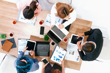 Wall Mural - Top view of businessman executive in group meeting with other businessmen and businesswomen in modern office with laptop computer, coffee and document on table. People corporate business team uds