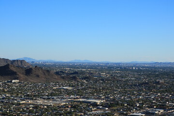 Wall Mural - Arizona Valley of the Sun or Greater Phoenix Metro area as seen from North Mountain Park hiking trails toward East on late afternoon, copy space