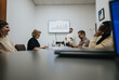 © qunica.com - A diverse group of professionals collaborate and discuss project details in an office setting, working together to analyze market opportunities and plan for business expansion.
