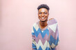 An enthusiastic young man wearing a strikingly vibrant sweater showcases his personality and style in a captivating portrait.