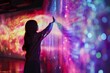 Woman experiences contact with technology, digital wall of LED lights.