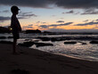 silhouette of a child on the beach at sunset