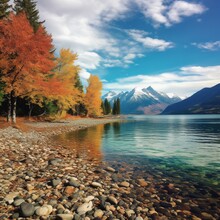 Lake McDonald, In The Fall, You'll See Trees Changing Color And Snowcapped Mountains 
