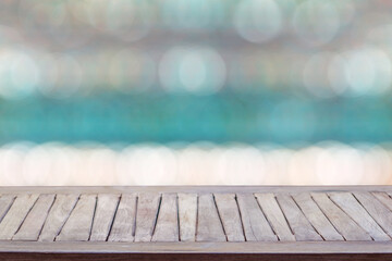 Wall Mural - Empty wooden table and abstract blurred seaside nature background. for product display