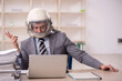 © Elnur - Young male employee wearing spacesuit in the office