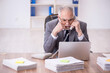 © Elnur - Old male employee and too much work in the office