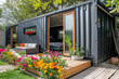 a modern container mini house with a flowers garden