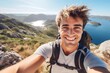 Young man with a backpack taking a selfie on a mountain