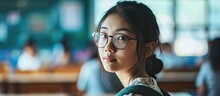Cute Asian Girl Holding Glasses In Classroom. Creative Banner. Copyspace Image
