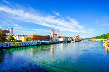 Wall Mural - View of some buildings and the surrounding landscape by the river in the city of Passau.
