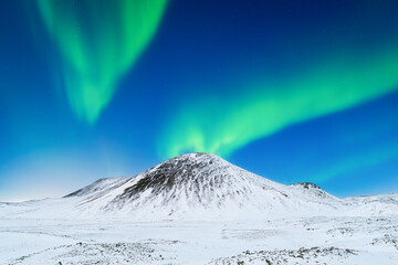 Wall Mural - Aurora Borealis. Northern Lights over the mountains. Scandinavia. Winter night landscape with bright lights in the sky. Landscape in the north in winter time.