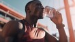Fitness, relax or black man drinking water in training or exercise for body recovery or workout in Chicago, USA. Hydration, thirsty or tired healthy sports athlete drinks natural liquid.