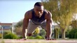 © haizah - Young man doing stretching exercise outside. African man training outside.