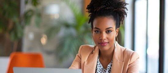 Poster - Stylish African American businesswoman doing an office interview, with laptop and copy space.