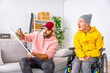 © unai - Man teaching to a disabled man at home