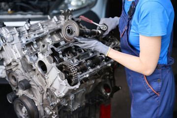 Wall Mural - Specialist is repairing large auto part in auto repair shop