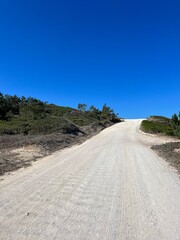 Wall Mural - Ground roads in the mountains, blue sky, hills, summer