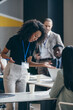 © gstockstudio - Surprised African female business mentor talking to audience and gesturing during a conference