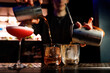 © 9parusnikov - Bartender making alcohol cocktail in a bar, close-Up.