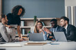 © gstockstudio - Concentrated group of business people planning strategy during team meeting at the office together
